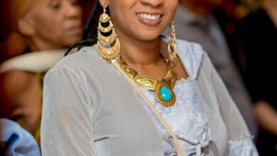 Empress Miriam Simone, a reggae artist and cultural ambassador, dressed in traditional Kente cloth, pays respect at a ceremony in Ghana.